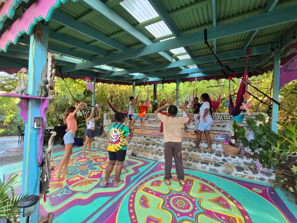 Children gathering in a colorful outdoor pavilion