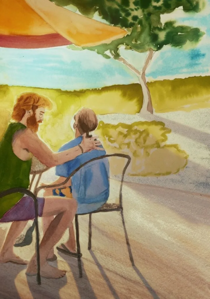 Couple sitting at a table with an umbrella