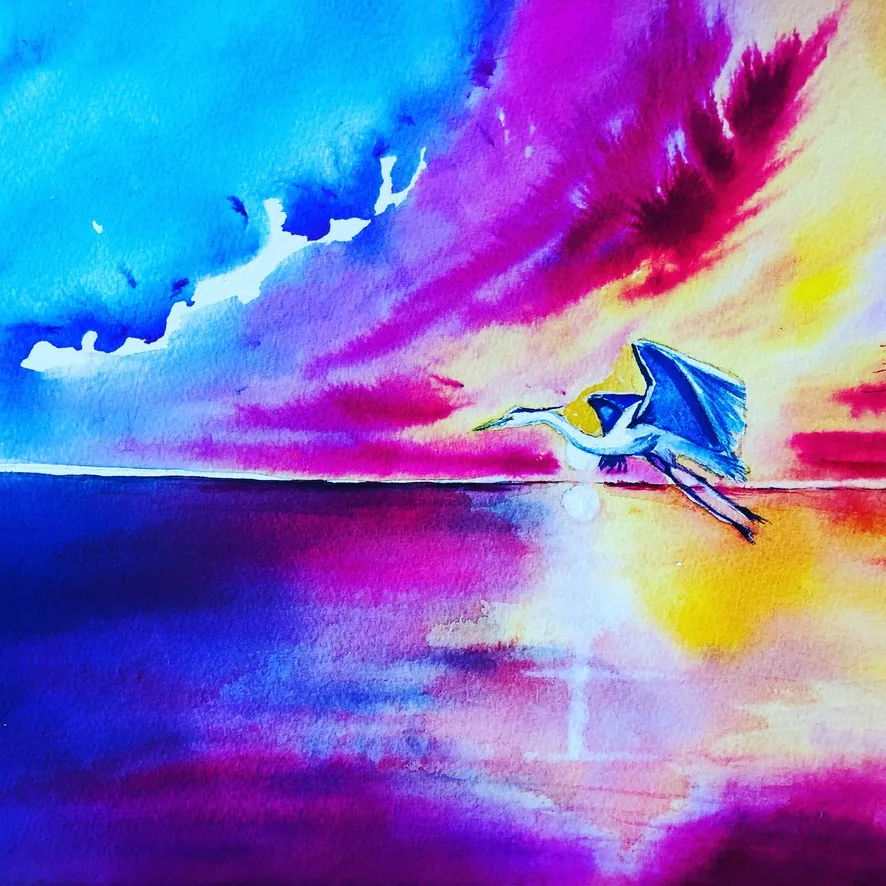 Bird flying across a vibrant pink and purple sunset